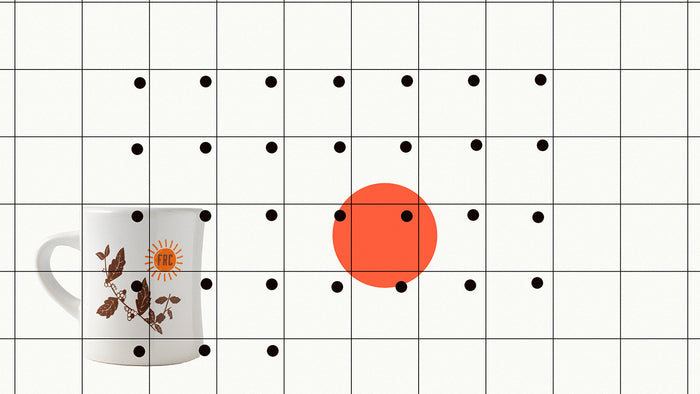 An minimalist calendar with a red dot on a date and a coffee mug in the background.