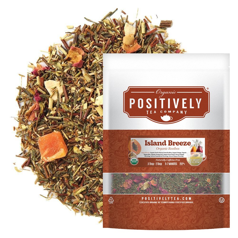 Positively Tea Company Island Breeze Rooibos tea, 16oz bag, displayed with loose leaf blend featuring tropical fruit pieces for a sweet, citrusy flavor.